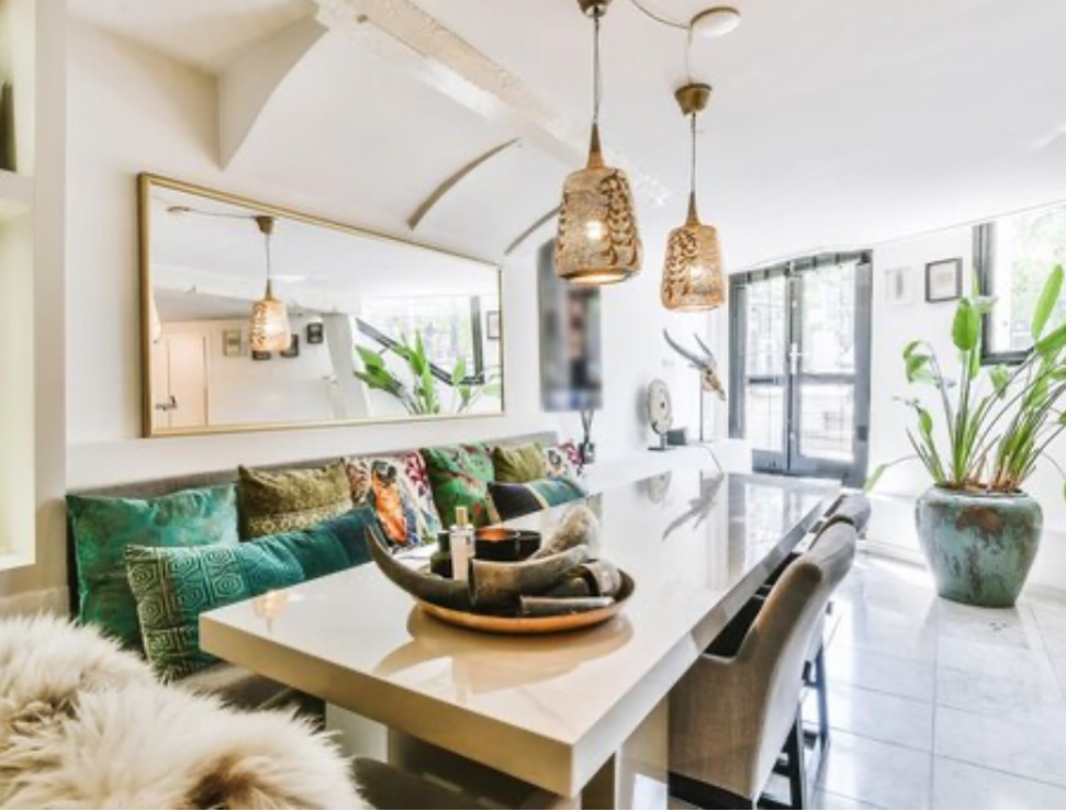 Bright boho dining nook with jewel-tone cushions